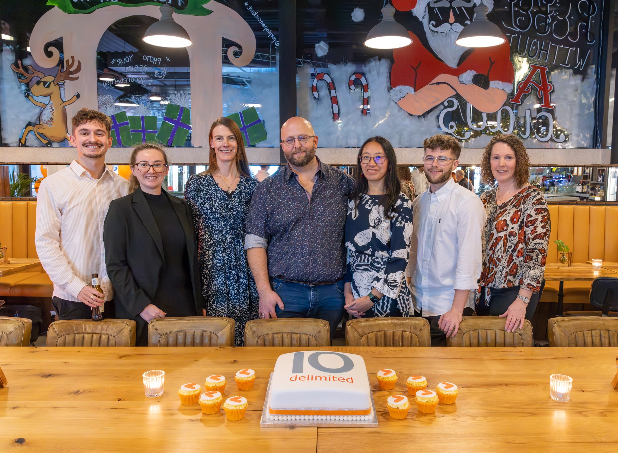 Delimited Team in front of a cake